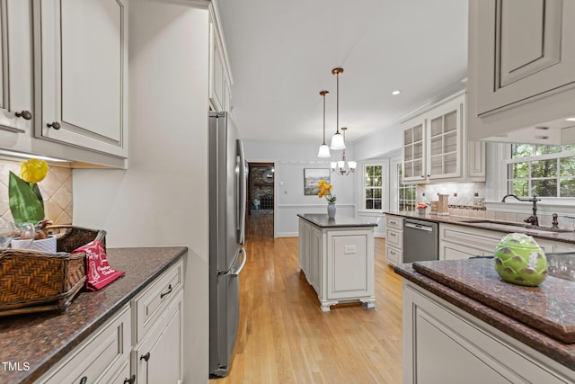 2840 Mattlyn Ct, Raleigh, NC 27613 - kitchen with stainless steel appliances, light wood-style flooring, glass insert cabinets, backsplash, and recessed lighting
