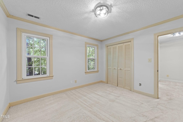 2840 Mattlyn Ct, Raleigh, NC 27613 - unfurnished bedroom with multiple windows, crown molding, a closet, a textured ceiling, and carpet flooring