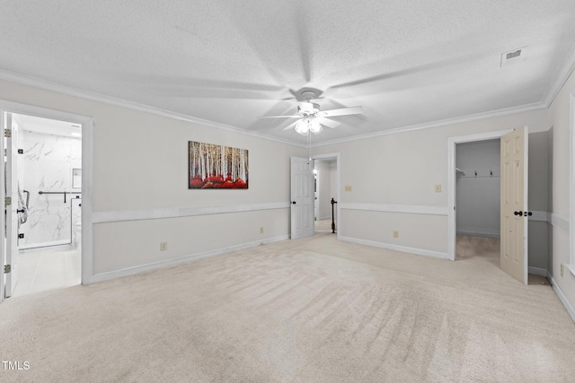 2840 Mattlyn Ct, Raleigh, NC 27613 - unfurnished bedroom with carpet flooring, crown molding, a textured ceiling, ensuite bath, and a walk in closet