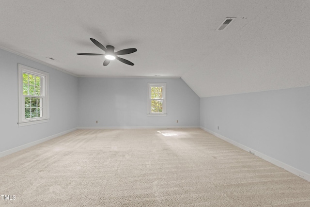 2840 Mattlyn Ct, Raleigh, NC 27613 - additional living space featuring a textured ceiling, baseboards, a ceiling fan, light carpet, and lofted ceiling