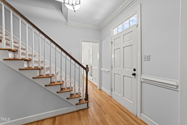 2840 Mattlyn Ct, Raleigh, NC 27613 - entrance foyer featuring ornamental molding, stairway, light wood-style flooring, and baseboards