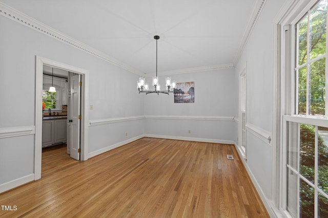 2840 Mattlyn Ct, Raleigh, NC 27613 - empty room featuring light wood finished floors, crown molding, a chandelier, and baseboards