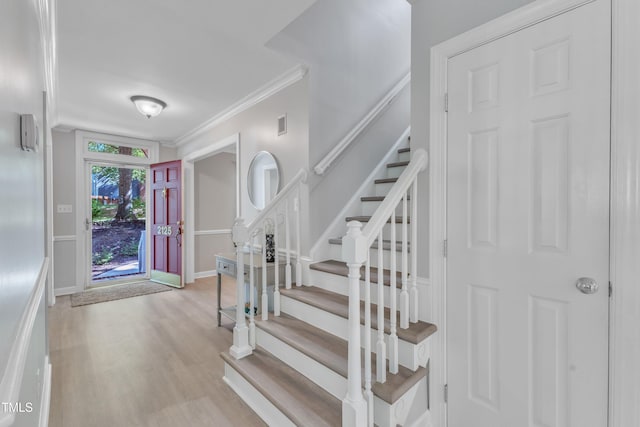 2125 Oakcrest Ct, Raleigh, NC 27612 - entryway featuring light wood-type flooring, ornamental molding, stairway, and baseboards