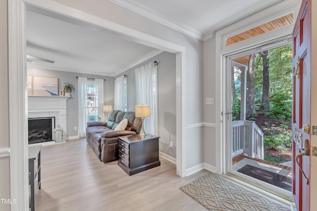 2125 Oakcrest Ct, Raleigh, NC 27612 - entrance foyer featuring plenty of natural light, light wood-style flooring, baseboards, crown molding, and a fireplace