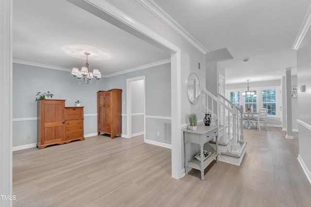 2125 Oakcrest Ct, Raleigh, NC 27612 - entrance foyer featuring a chandelier, light wood-style floors, baseboards, and crown molding