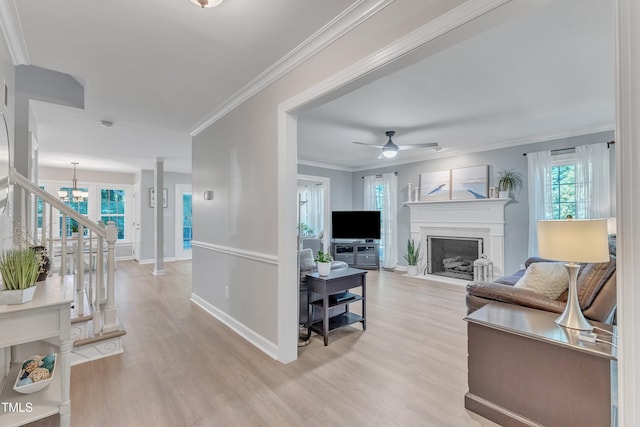 2125 Oakcrest Ct, Raleigh, NC 27612 - living room featuring light wood-style flooring, a chandelier, baseboards, a fireplace with flush hearth, and ceiling fan