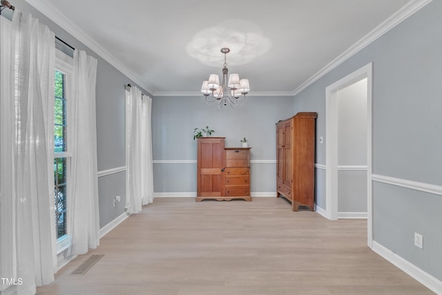 2125 Oakcrest Ct, Raleigh, NC 27612 - dining space with a chandelier, light wood-type flooring, crown molding, and baseboards