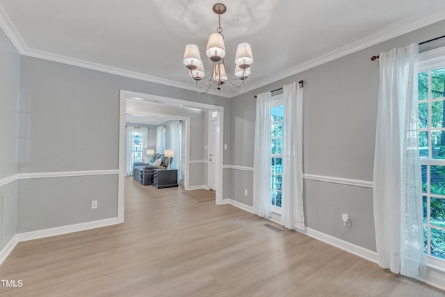 2125 Oakcrest Ct, Raleigh, NC 27612 - unfurnished dining area with wood finished floors, healthy amount of natural light, baseboards, and ornamental molding