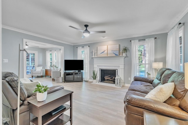 2125 Oakcrest Ct, Raleigh, NC 27612 - living area featuring light wood-style flooring, ceiling fan, ornamental molding, a fireplace with flush hearth, and baseboards