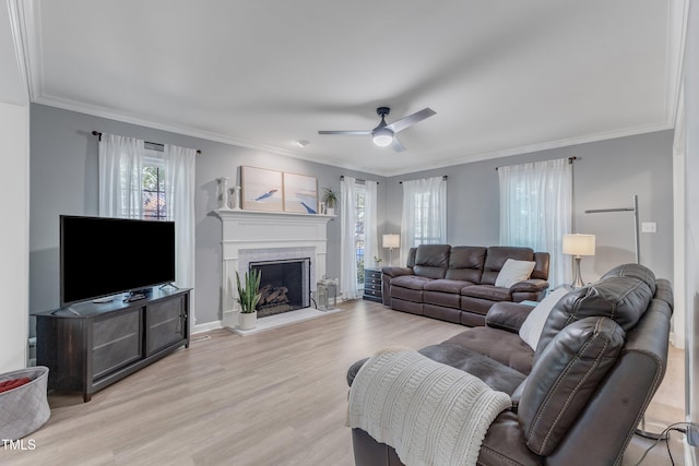 2125 Oakcrest Ct, Raleigh, NC 27612 - living room featuring light wood-style floors, crown molding, ceiling fan, a brick fireplace, and baseboards
