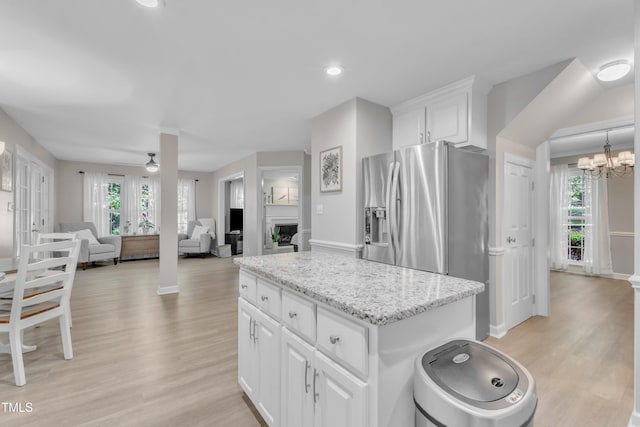 2125 Oakcrest Ct, Raleigh, NC 27612 - kitchen with stainless steel fridge, light wood-style flooring, plenty of natural light, white cabinets, and recessed lighting