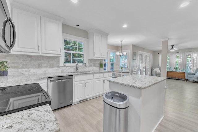2125 Oakcrest Ct, Raleigh, NC 27612 - kitchen featuring black appliances, a sink, light wood finished floors, healthy amount of natural light, and recessed lighting