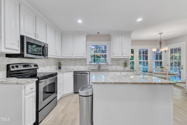 2125 Oakcrest Ct, Raleigh, NC 27612 - kitchen featuring stainless steel appliances, light wood-type flooring, healthy amount of natural light, and recessed lighting