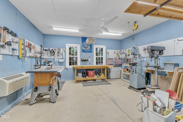 2125 Oakcrest Ct, Raleigh, NC 27612 - miscellaneous room with a workshop area, concrete floors, and a wall mounted air conditioner