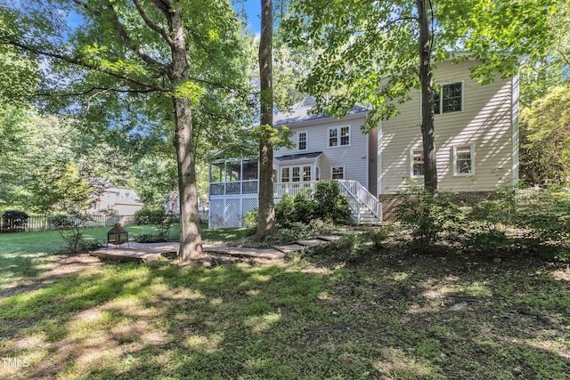 2125 Oakcrest Ct, Raleigh, NC 27612 - back of property with a sunroom, stairway, and a deck