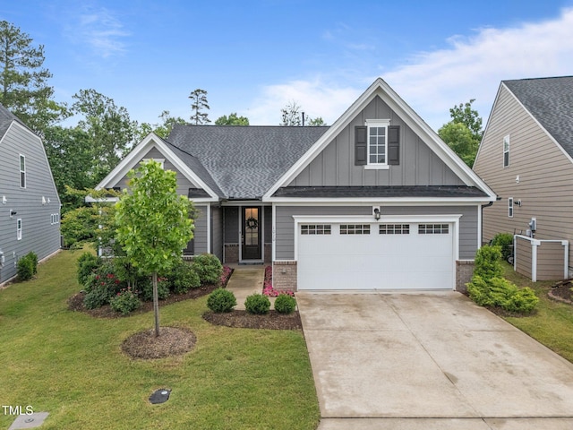 1010 Sandbar Ln, Durham, NC 27703 - craftsman-style house with board and batten siding, brick siding, a front lawn, and concrete driveway