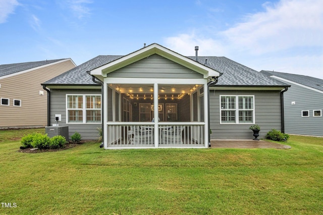 1010 Sandbar Ln, Durham, NC 27703 - rear view of house with roof with shingles, cooling unit, a sunroom, a lawn, and a patio