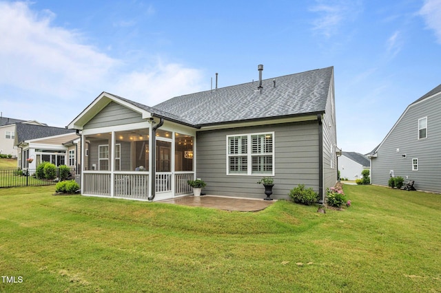 1010 Sandbar Ln, Durham, NC 27703 - rear view of property featuring a shingled roof, a sunroom, and a patio area