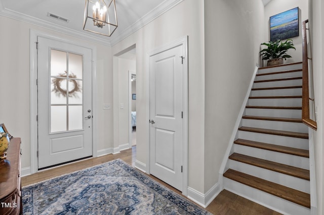 1010 Sandbar Ln, Durham, NC 27703 - entrance foyer featuring a chandelier, baseboards, stairs, wood finished floors, and ornamental molding