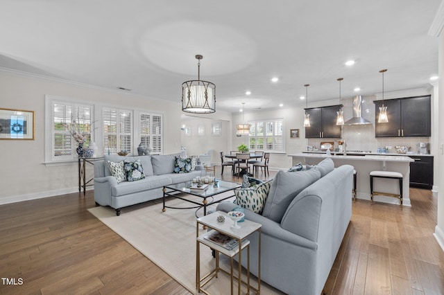 1010 Sandbar Ln, Durham, NC 27703 - living area with wood finished floors, recessed lighting, ornamental molding, and baseboards