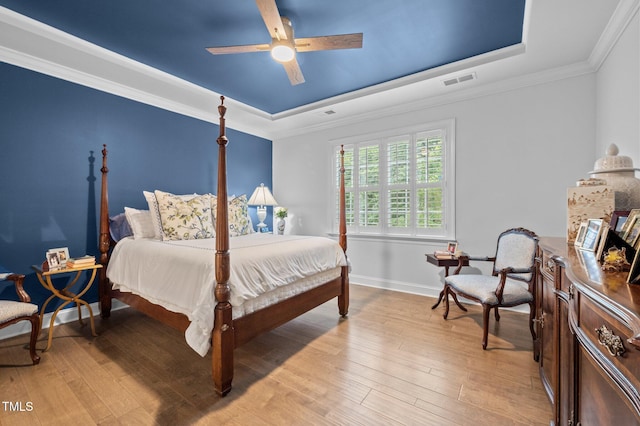 1010 Sandbar Ln, Durham, NC 27703 - bedroom featuring a raised ceiling, light wood-style flooring, crown molding, baseboards, and ceiling fan