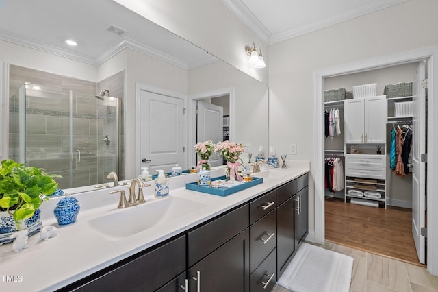 1010 Sandbar Ln, Durham, NC 27703 - full bath featuring double vanity, a stall shower, crown molding, and a walk in closet