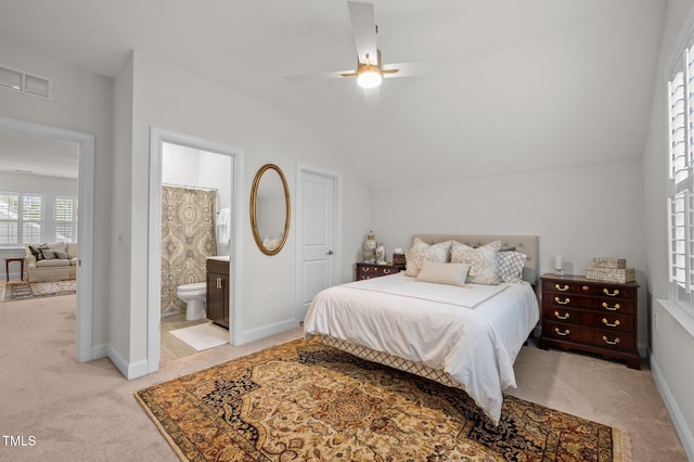 1010 Sandbar Ln, Durham, NC 27703 - bedroom featuring light carpet, lofted ceiling, ensuite bathroom, baseboards, and a ceiling fan