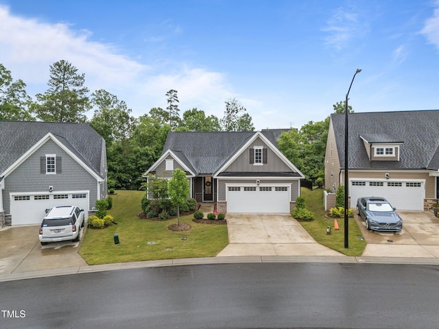 1010 Sandbar Ln, Durham, NC 27703 - craftsman house with stone siding, a front lawn, concrete driveway, and a garage