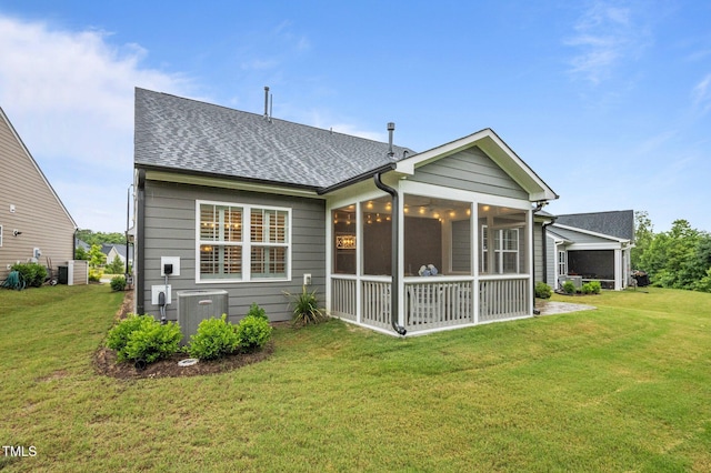 1010 Sandbar Ln, Durham, NC 27703 - back of property featuring central AC, a sunroom, a lawn, and a shingled roof
