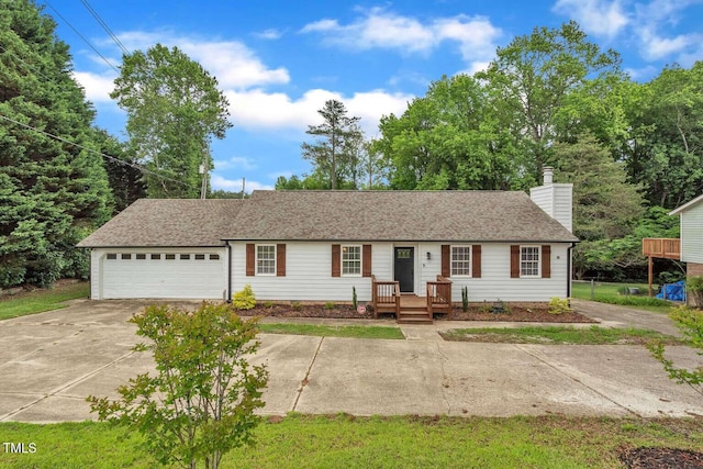ranch-style home with driveway, a garage, and a chimney