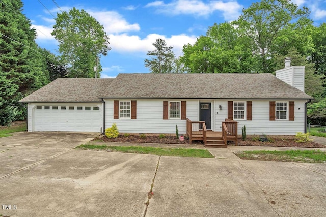 ranch-style house featuring concrete driveway, a chimney, a garage, and roof with shingles