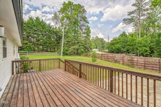 wooden terrace featuring view of wooded area
