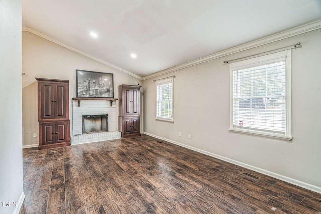 unfurnished living room with a fireplace, wood finished floors, baseboards, vaulted ceiling, and crown molding
