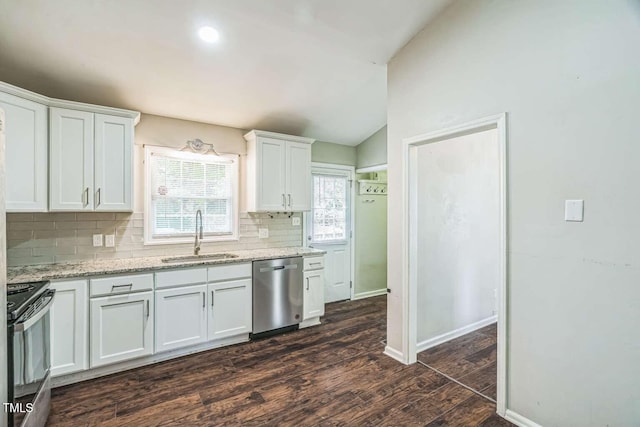 kitchen with dishwasher, a sink, black / electric stove, tasteful backsplash, and dark wood-style flooring