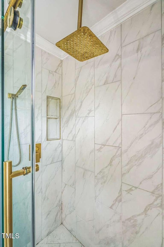 bathroom featuring a shower stall and crown molding