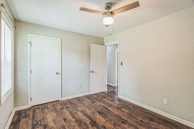 unfurnished bedroom featuring wood finished floors, baseboards, and ceiling fan