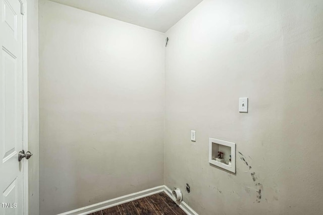 washroom with hookup for a washing machine, dark wood-type flooring, and baseboards