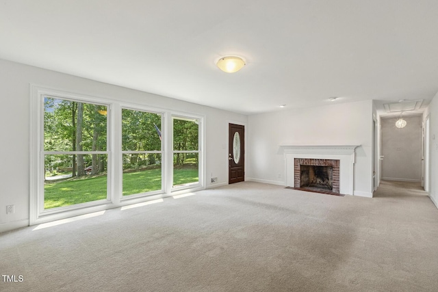 418 S W St, Cary, NC 27511 - unfurnished living room featuring carpet, baseboards, attic access, and a fireplace
