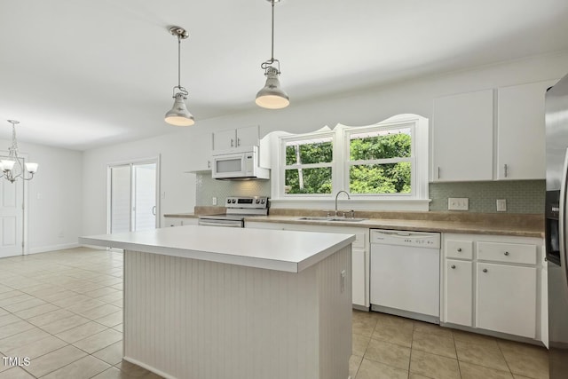 418 S W St, Cary, NC 27511 - kitchen featuring white appliances, a sink, light tile patterned floors, and backsplash
