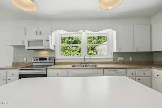 418 S W St, Cary, NC 27511 - kitchen featuring white appliances, a sink, backsplash, white cabinets, and crown molding