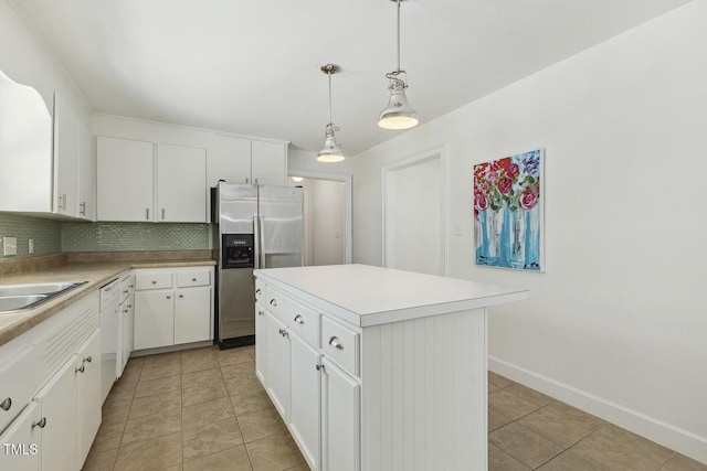 418 S W St, Cary, NC 27511 - kitchen with stainless steel fridge, backsplash, baseboards, white cabinets, and light countertops