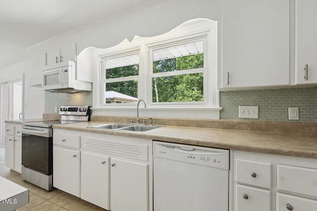 418 S W St, Cary, NC 27511 - kitchen featuring white appliances, a sink, white cabinets, tasteful backsplash, and light tile patterned floors