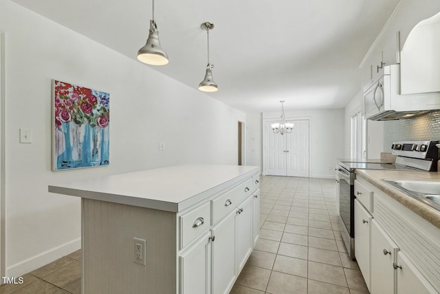 418 S W St, Cary, NC 27511 - kitchen featuring stainless steel electric range oven, light tile patterned floors, a chandelier, light countertops, and white cabinetry