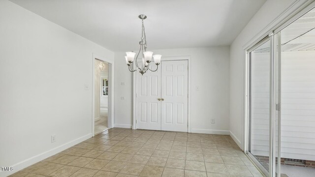 418 S W St, Cary, NC 27511 - unfurnished dining area with a chandelier and baseboards