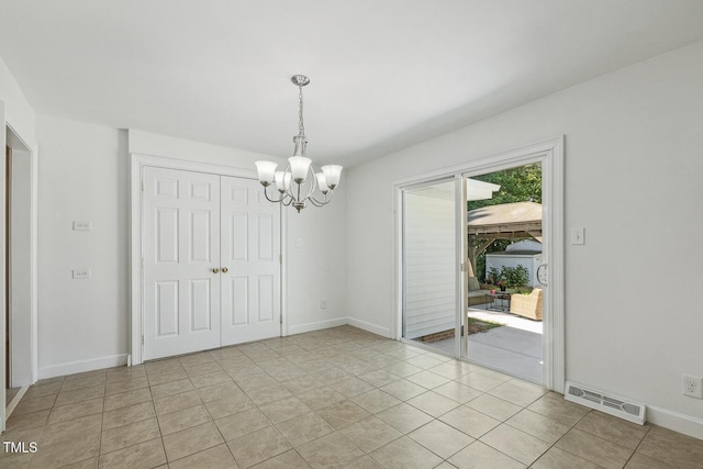 418 S W St, Cary, NC 27511 - unfurnished dining area with a chandelier, baseboards, and light tile patterned floors