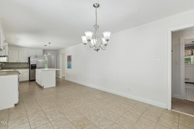 418 S W St, Cary, NC 27511 - kitchen with stainless steel refrigerator with ice dispenser, a chandelier, light tile patterned floors, and a sink