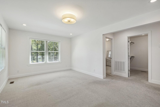 418 S W St, Cary, NC 27511 - unfurnished bedroom featuring carpet, a walk in closet, baseboards, and recessed lighting