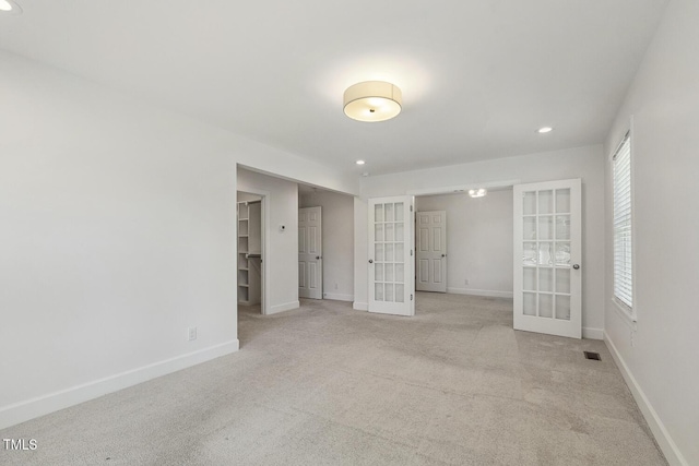 418 S W St, Cary, NC 27511 - unfurnished bedroom with french doors, recessed lighting, baseboards, carpet floors, and multiple windows