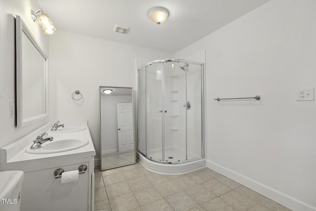 418 S W St, Cary, NC 27511 - bathroom with a shower stall, baseboards, tile patterned flooring, and double vanity