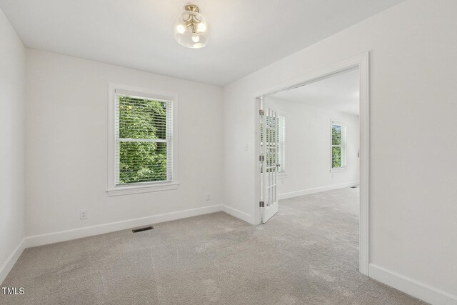 418 S W St, Cary, NC 27511 - carpeted spare room featuring plenty of natural light, baseboards, and a chandelier